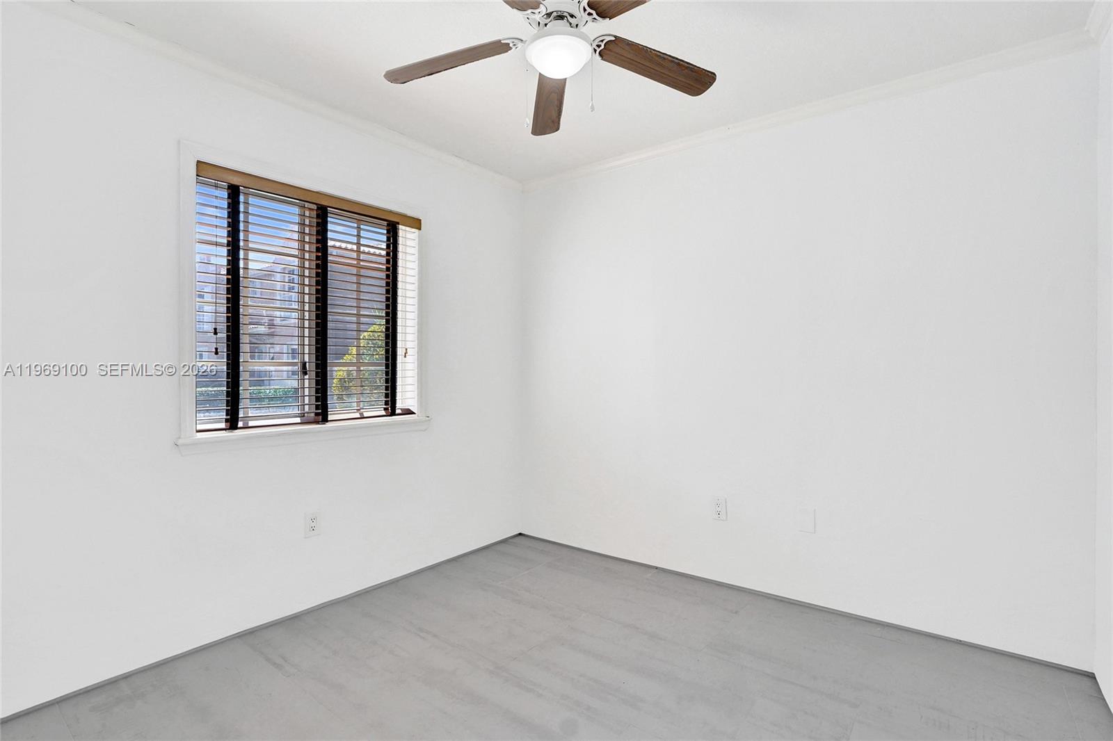 7783 Southwest 94th Lane, Unit 7783 Miami, FL 33156 - Photo 12 of 30 an empty room with a window