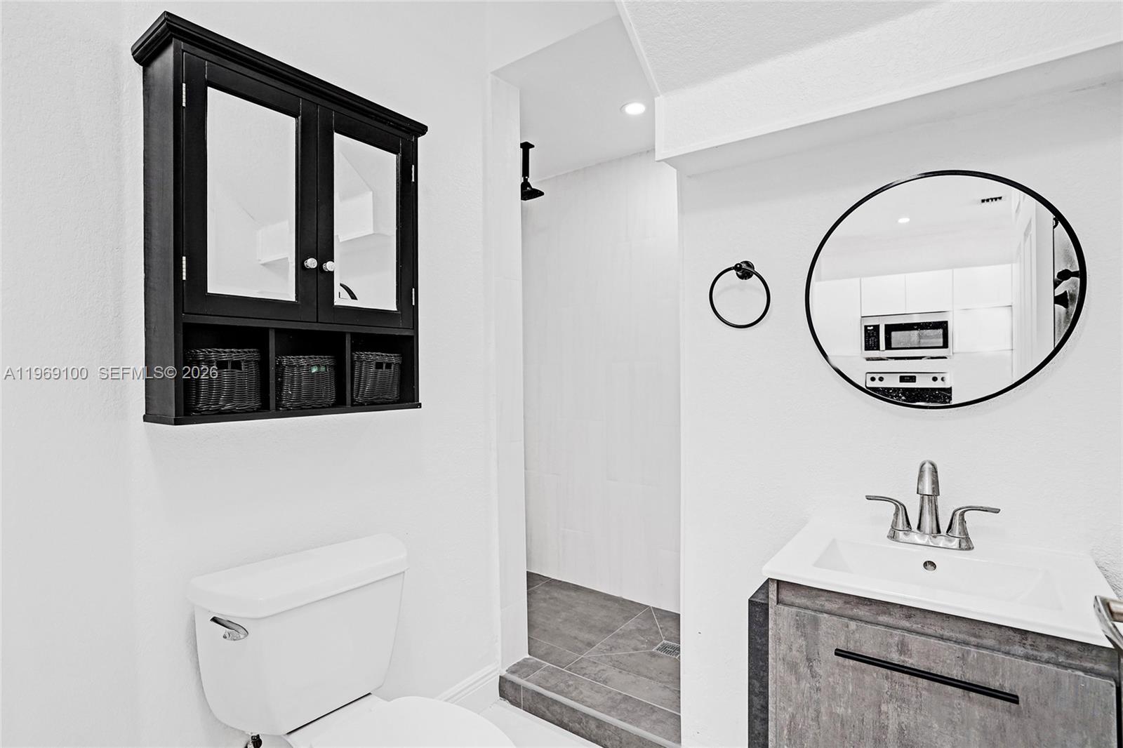 7783 Southwest 94th Lane, Unit 7783 Miami, FL 33156 - Photo 14 of 30 a bathroom with a toilet a sink and a mirror