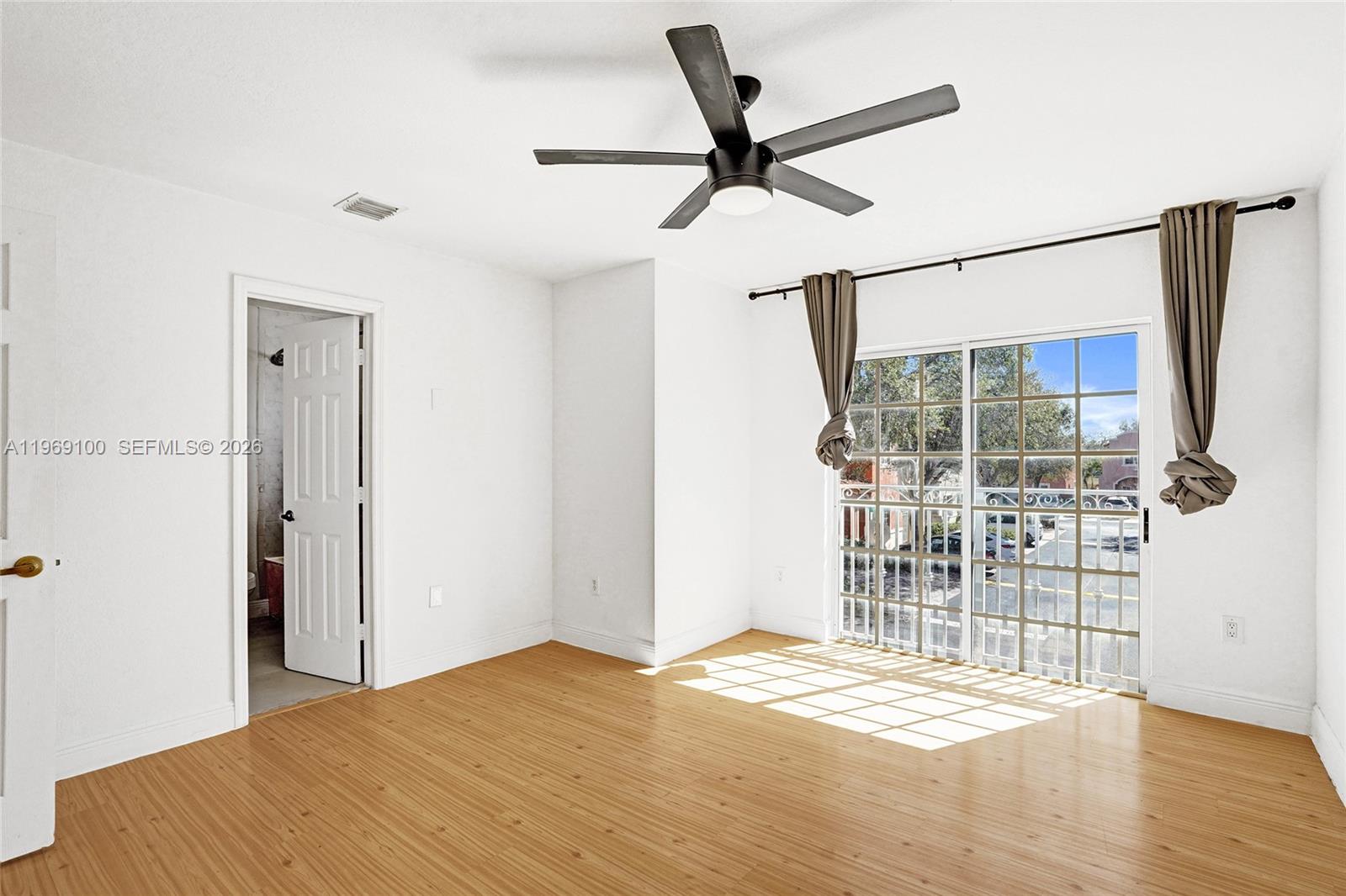 7783 Southwest 94th Lane, Unit 7783 Miami, FL 33156 - Photo 16 of 30 a view of empty room with wooden floor and fan