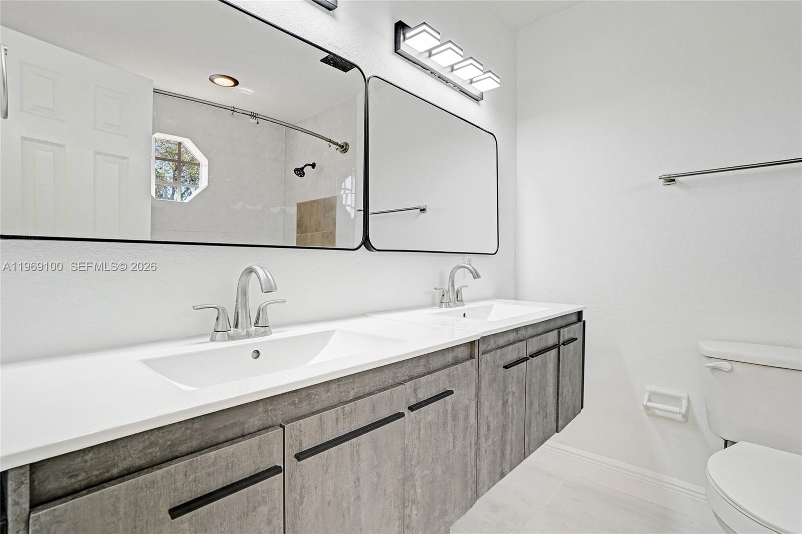7783 Southwest 94th Lane, Unit 7783 Miami, FL 33156 - Photo 17 of 30 a bathroom with a sink and a mirror