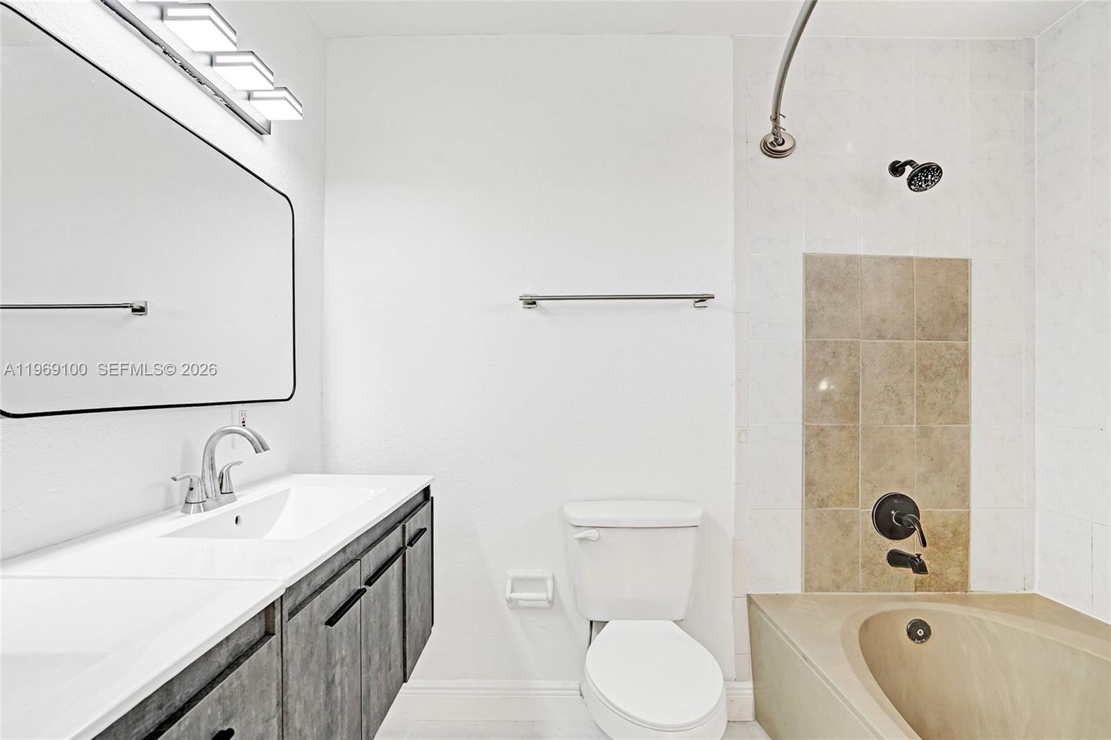7783 Southwest 94th Lane, Unit 7783 Miami, FL 33156 - Photo 18 of 30 a bathroom with a sink a toilet and shower