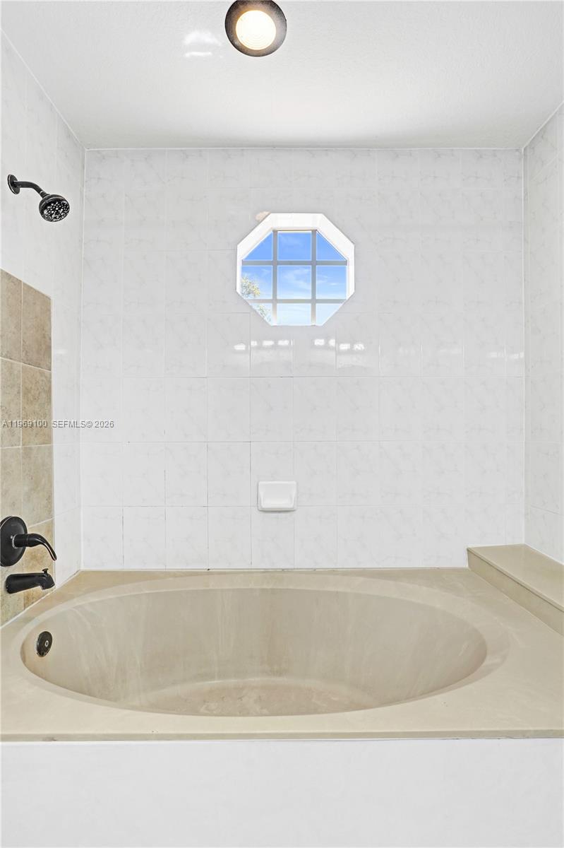 7783 Southwest 94th Lane, Unit 7783 Miami, FL 33156 - Photo 19 of 30 a bathroom with a tub