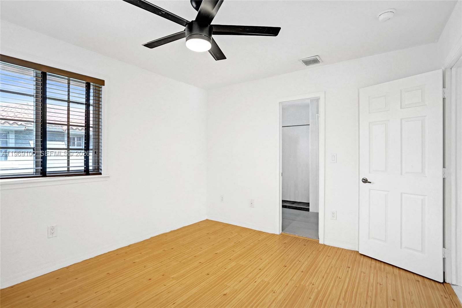 7783 Southwest 94th Lane, Unit 7783 Miami, FL 33156 - Photo 21 of 30 a view of a big room with wooden floor and a window