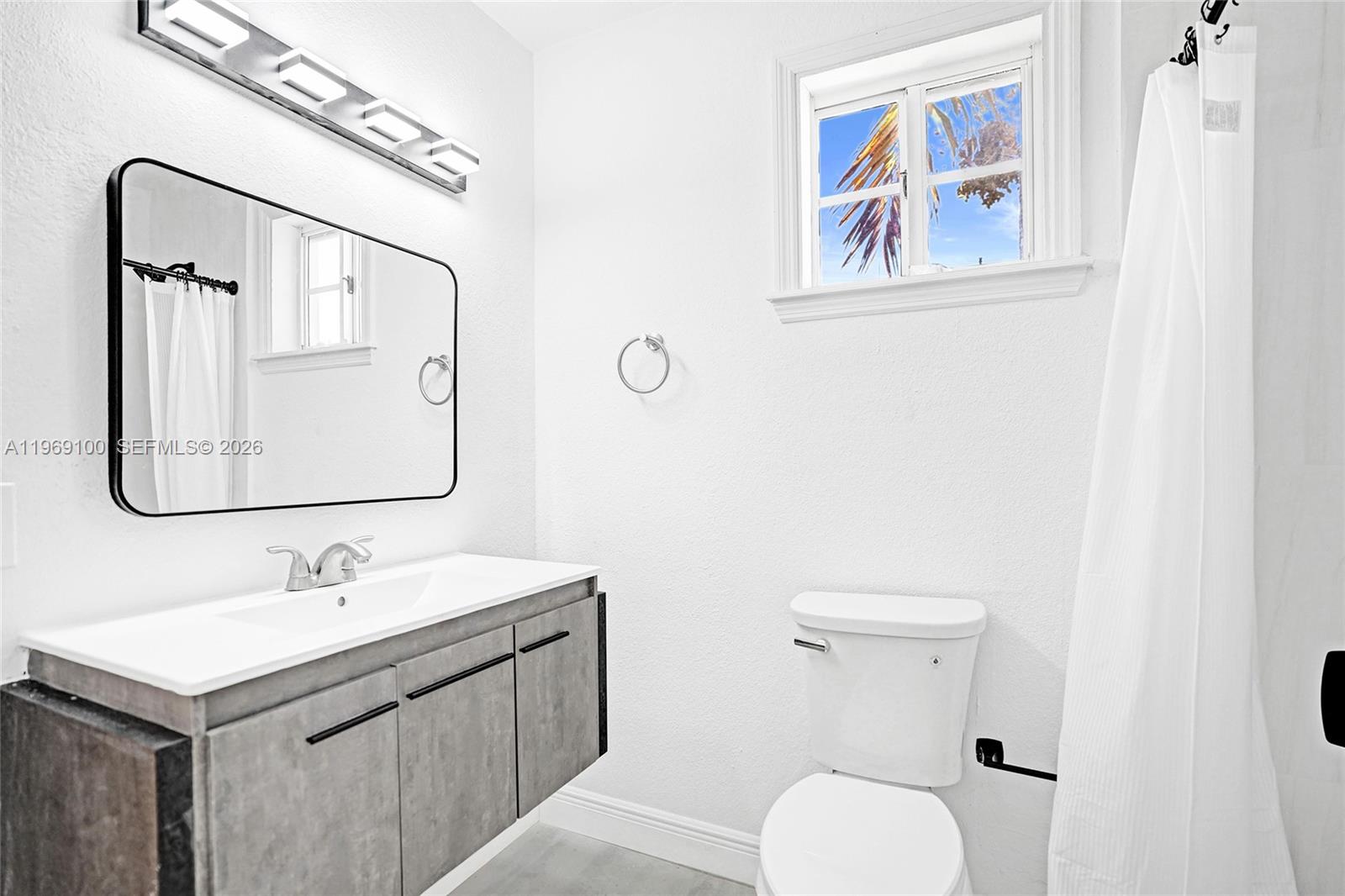 7783 Southwest 94th Lane, Unit 7783 Miami, FL 33156 - Photo 24 of 30 a bathroom with a toilet sink and mirror