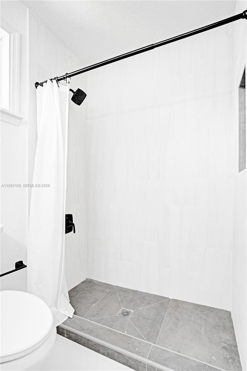 7783 Southwest 94th Lane, Unit 7783 Miami, FL 33156 - Photo 26 of 30 a bathroom with a shower and a toilet