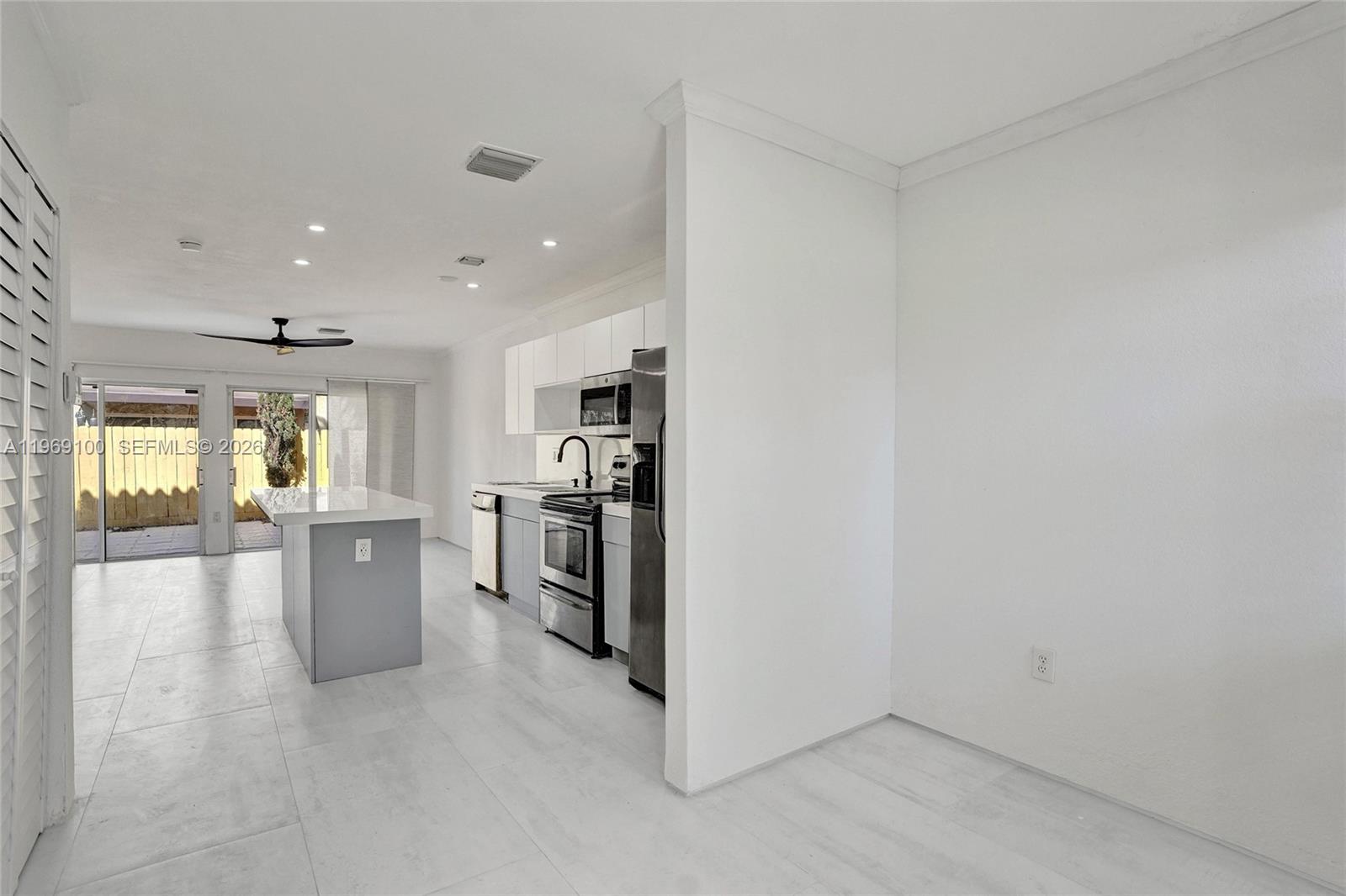 7783 Southwest 94th Lane, Unit 7783 Miami, FL 33156 - Photo 3 of 30 a view of a kitchen with refrigerator and windows