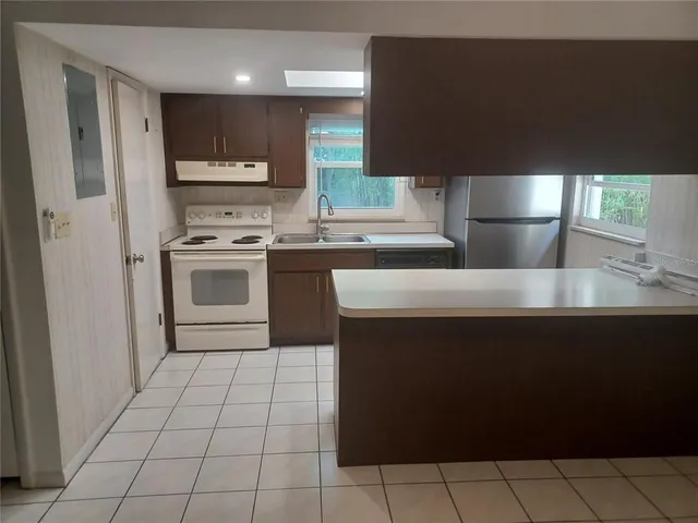 a kitchen with stainless steel appliances a sink stove and refrigerator