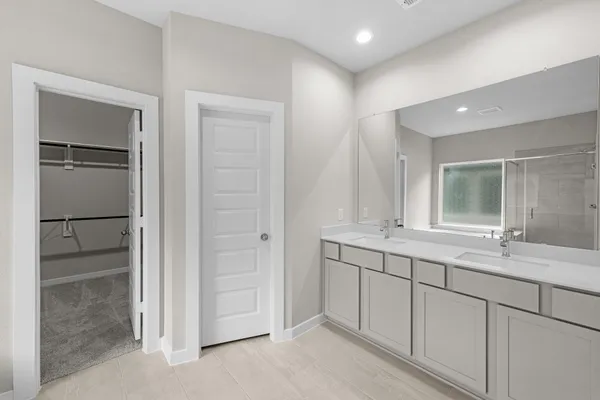 a bathroom with a double vanity sink and a mirror