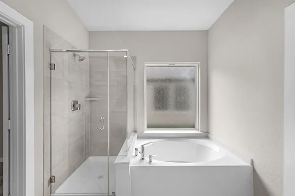 a bathroom with a bathtub and a shower