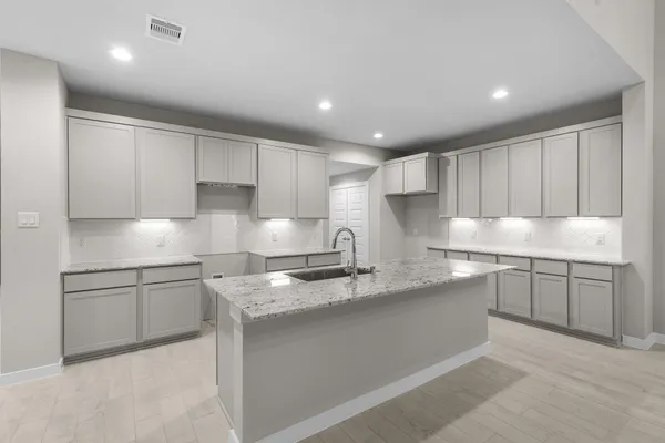 a kitchen with stainless steel appliances granite countertop a sink and cabinets