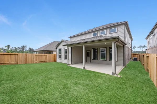 a view of house with backyard
