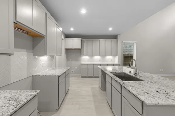 a kitchen with stainless steel appliances granite countertop a sink and stove