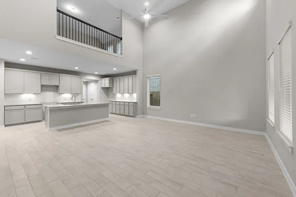 a view of kitchen with refrigerator and cabinets
