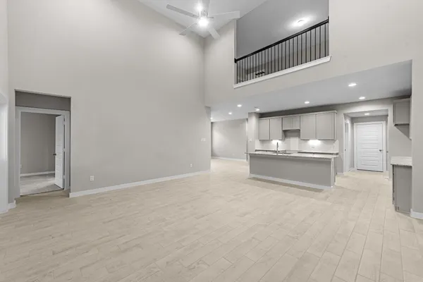 a view of kitchen with kitchen island white cabinets and refrigerator