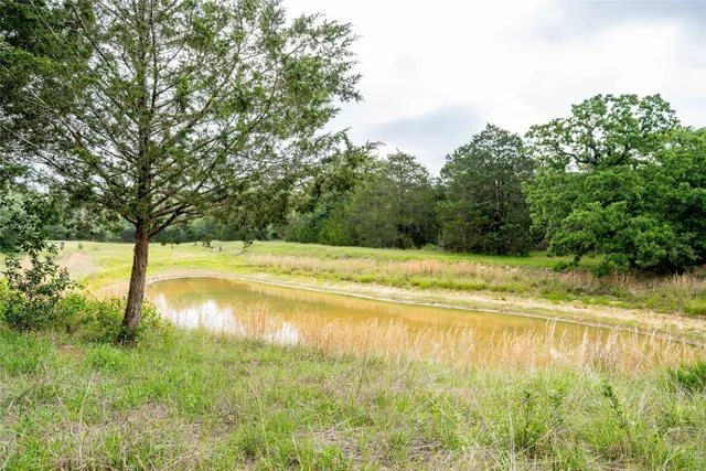 a view of a swimming pool and a yard