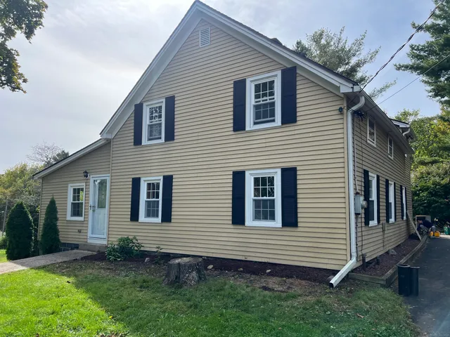 a front view of a house with a garden