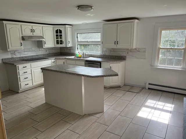 a kitchen with stainless steel appliances granite countertop a sink and a stove