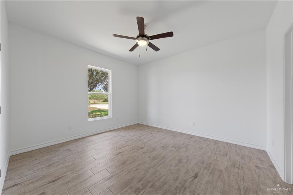 15688 Primera Road Harlingen, TX 78552 - Photo 11 of 20 an empty room with window and ceiling fan
