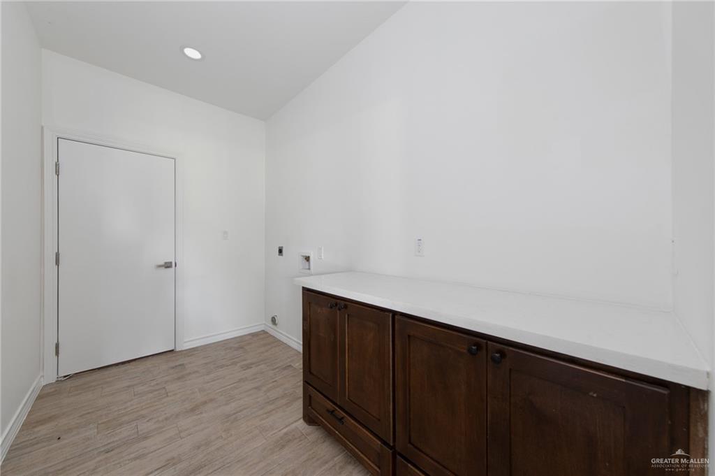 15688 Primera Road Harlingen, TX 78552 - Photo 13 of 20 a room with a sink and cabinets