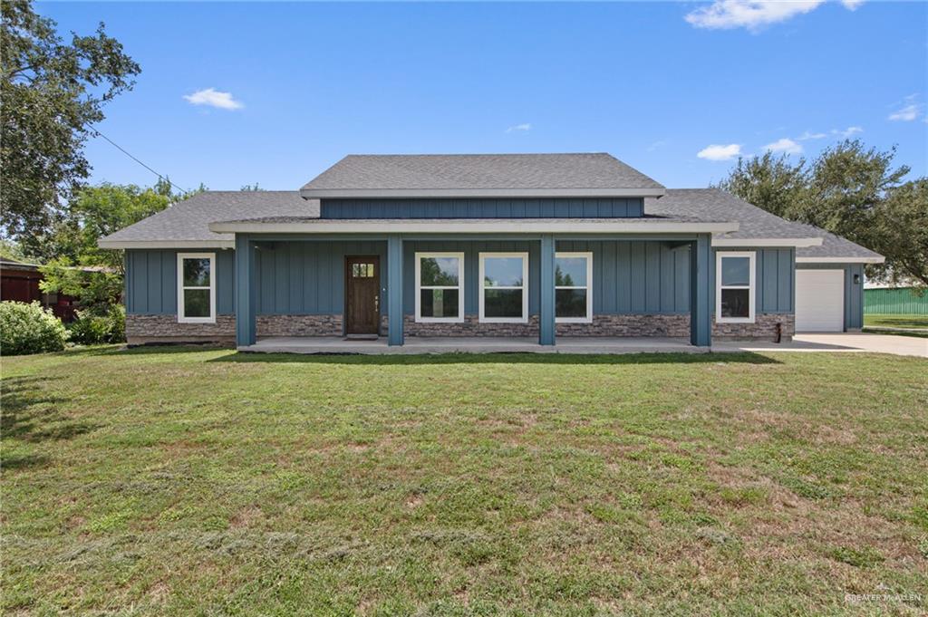 15688 Primera Road Harlingen, TX 78552 - Photo 2 of 20 a front view of a house with a garden