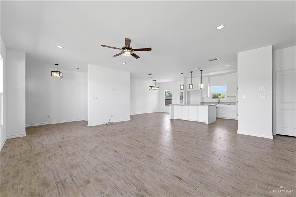 15688 Primera Road Harlingen, TX 78552 - Photo 4 of 20 a view of a kitchen with a sink and dishwasher a refrigerator with wooden floor
