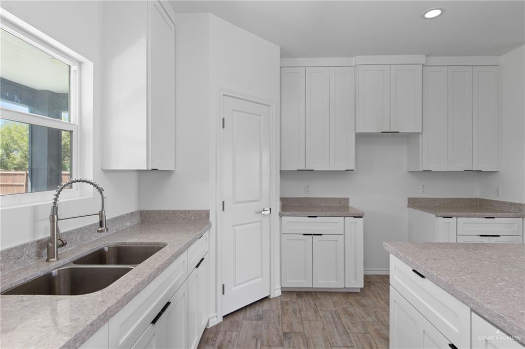 15688 Primera Road Harlingen, TX 78552 - Photo 7 of 20 a kitchen with white cabinets sink and dishwasher