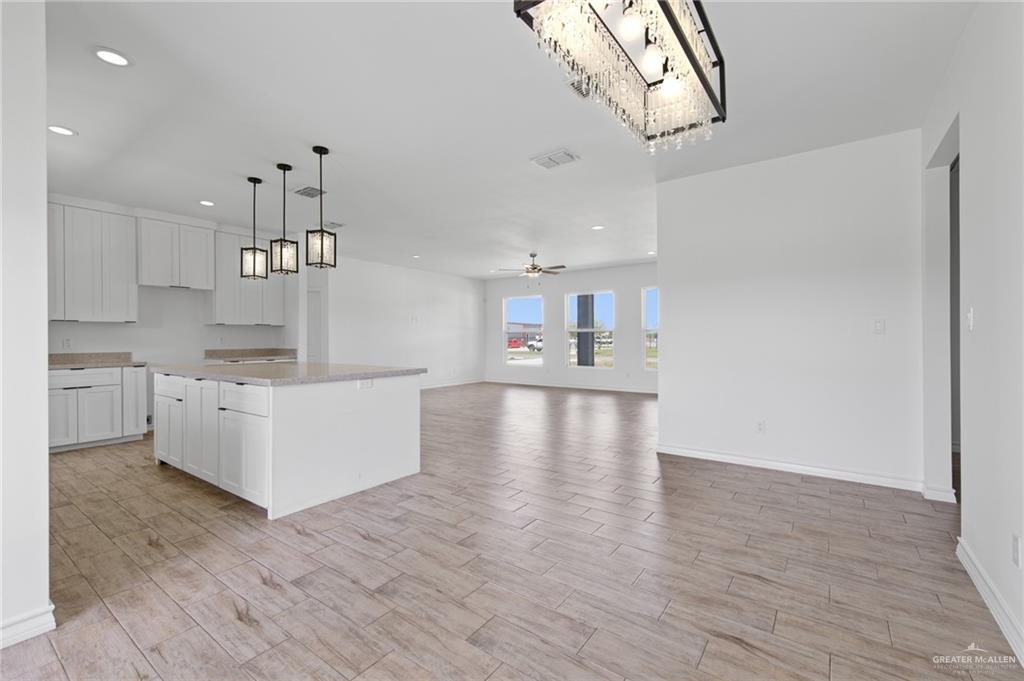 15688 Primera Road Harlingen, TX 78552 - Photo 8 of 20 a kitchen with stainless steel appliances granite countertop a sink a stove and a wooden floors
