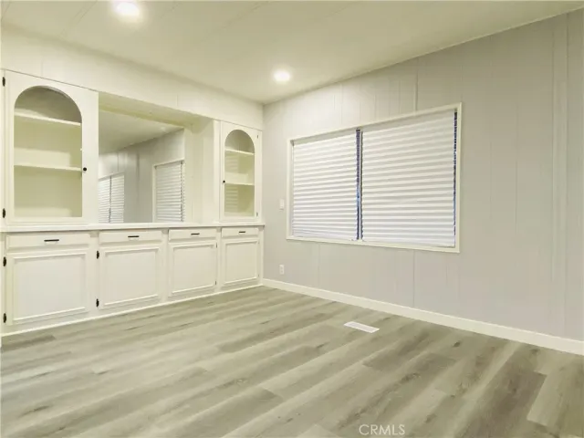 a view of a livingroom with wooden floor and white doors