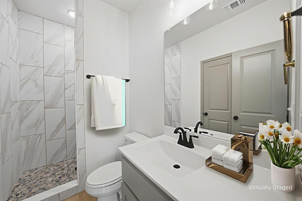 103 South Barron Street Covington, TX 76636 - Photo 12 of 16 a bathroom with a sink toilet and shower