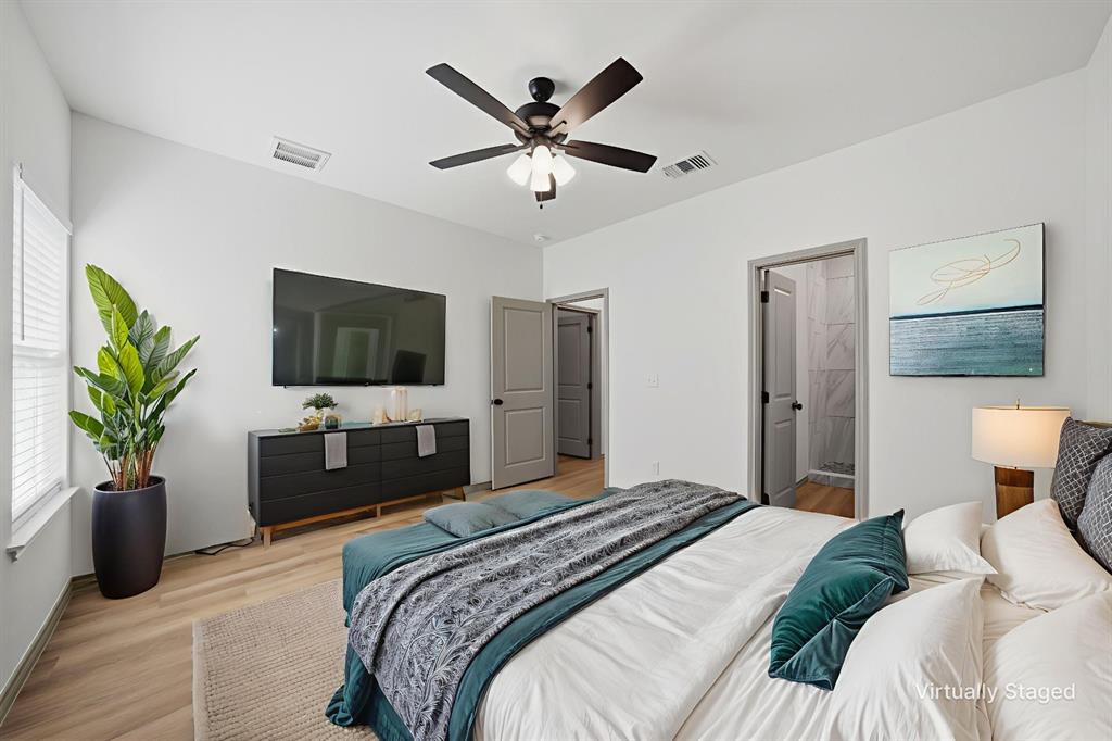 103 South Barron Street Covington, TX 76636 - Photo 10 of 16 a bedroom with a bed and a flat screen tv