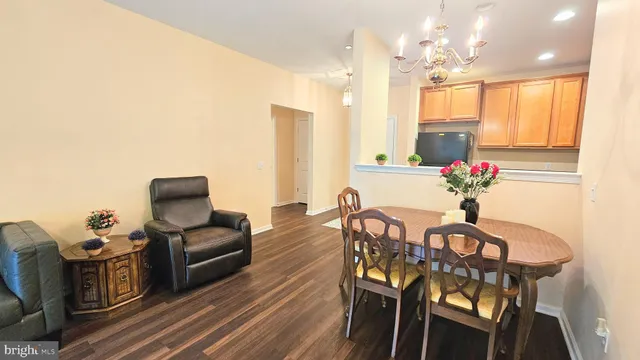 a view of a dining room with furniture and a chandelier