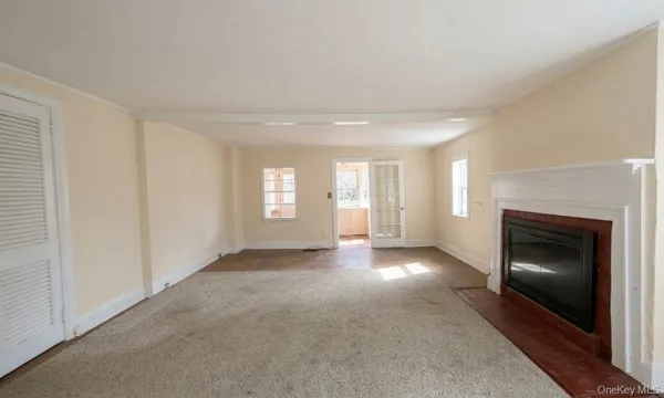 a view of a livingroom with a fireplace and window