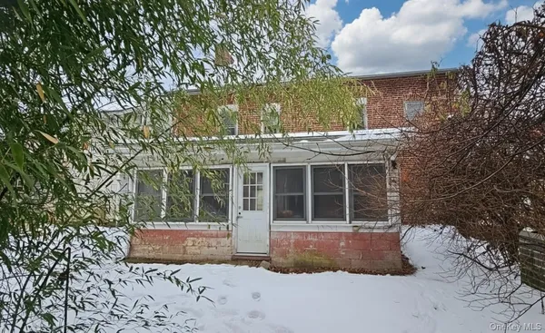 an empty room with windows and entrance