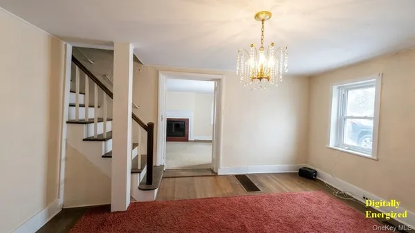 a view of a hallway with windows and chandelier