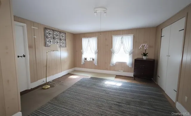 a view of a dining room with furniture and a potted plant