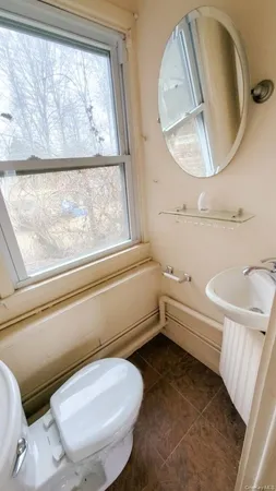 a bathroom with a toilet and a mirror