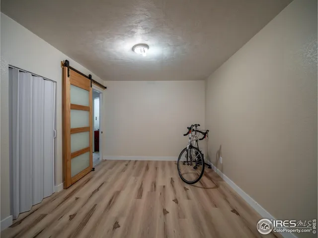 a living room with a couch and a wooden floor