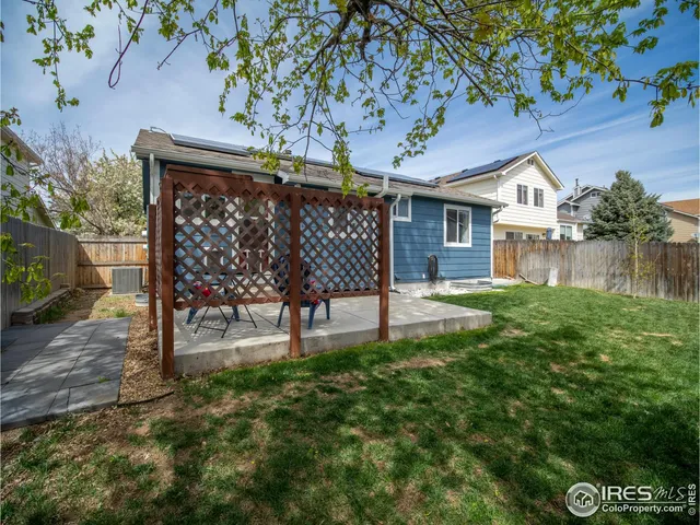 a front view of house with yard and outdoor seating