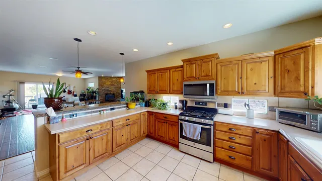 a kitchen with white cabinets sink and stainless steel appliances