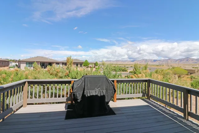 a view of a balcony with wooden floor and fence