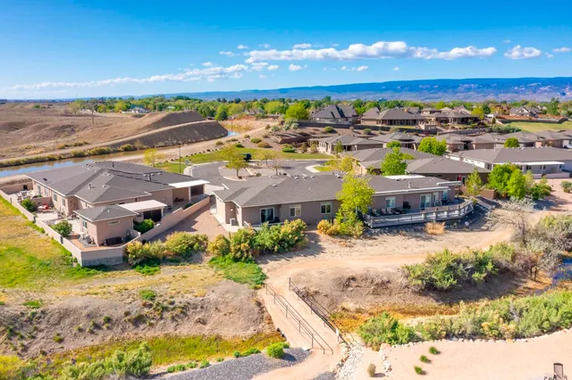 an aerial view of a house with a swimming pool yard and mountain view in back