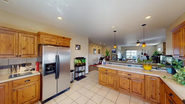 a kitchen with stainless steel appliances a refrigerator sink and cabinets
