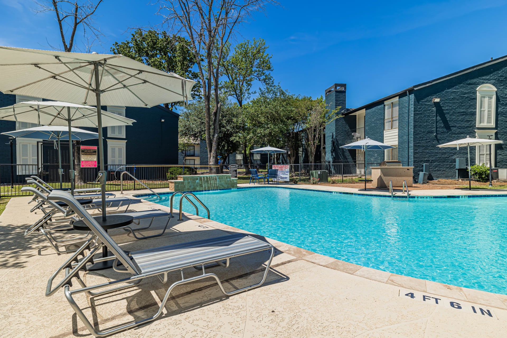 200 Hollow Tree Lane, Unit 17062 Houston, TX 77090 - Photo 13 of 16 a view of a patio with chairs and a table under an umbrella