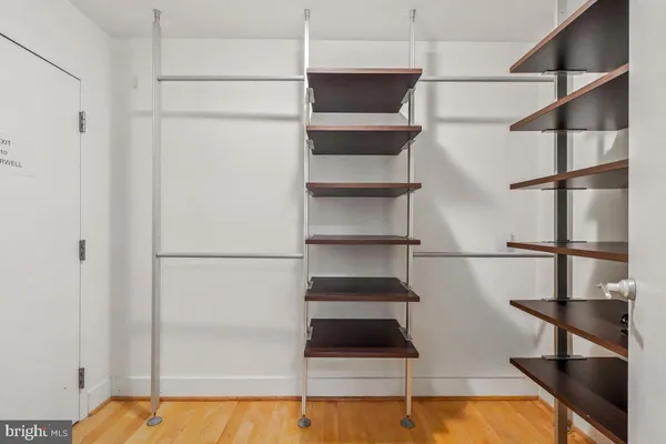 a view of walk in closet with empty racks