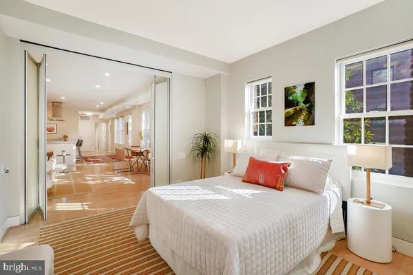 a bedroom with a large bed and a large window