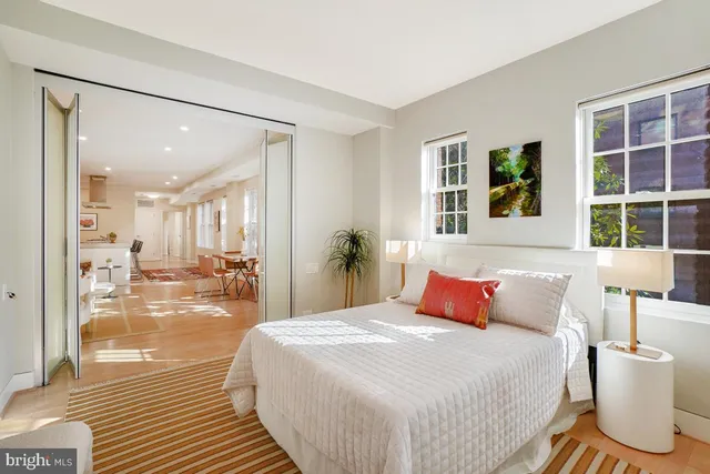 a bedroom with a large bed and a large window