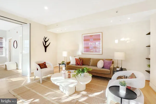 a living room with furniture and a wooden floor