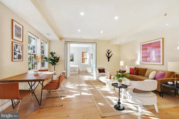 a living room with fireplace furniture and a table