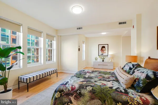 a bedroom with a bed couch and a window