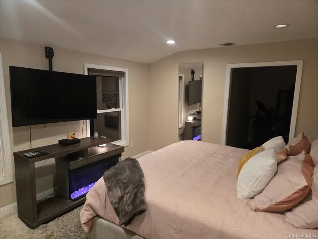 a view of a room with furniture and a flat screen tv